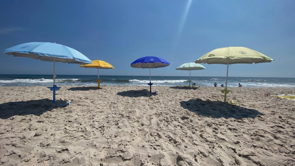 variety of Anchor Works beach umbrellas on the beach