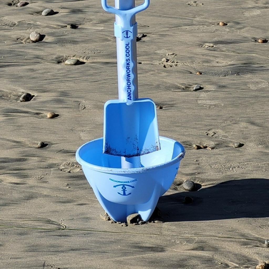 The Anchor by Anchor Works and shovel on a beach